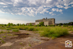 The Westinghouse "C" building at the edge of a concrete field. This building is going to be saved and repurposed.